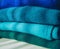 Stack of blue to green gradient cachemire clothes