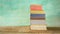 Stack of books against grungy background,