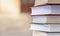 A stack of books on the background of school entrance