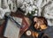 Stack of books, candle, autumn leaves, knitted plaid - cozy home still life on a dark background, top view