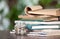 A stack of books and a glass can full of euro coins