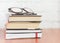 Stack of books and glasses on the table,fiction for reading