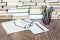 Stack of books, hardback books on wooden table, open book, notebook and glasses, copy space for text