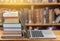 Stack of books with laptop on wooden table