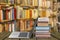 Stack of books with laptop on wooden table