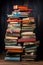 A stack of books, magazines and newspapers sitting on top of a wooden table