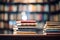 Stack of books on the table in library. Education and learning concept, book stack with ladder on sky with clouds background