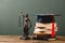 Stack of books, themis statuette and academic cap on wooden surface