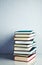 Stack of books on white reflective surface