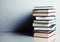 Stack of books on white reflective surface