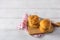 Stack of bread buns on wooden cutting board