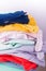Stack of bright female trousers. Folded colorful pants and jeans. Close up