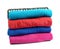 Stack of bright terry towels on white background