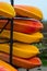 Stack of brightly colored kayaks