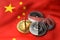 Stack of broken or cracked cryptocurrency coins on Chinese flag. Situation of Cryptocurrencies in China concept. 3D Rendering