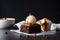 Stack of brownie squares with scoop of ice cream and caramel, white background