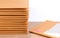 Stack of bubble wrap padded mailing envelopes on white background color over wooden table.