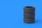 Stack of car tyres on blue background. Automotive parts. Traffic safety