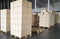 Stack of cardboard boxes on wooden pallets, shipment package boxes, interior of warehouse storage.