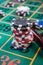 Stack of casino chips on green felt roulette table with lucky numbers