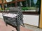 Stack of chairs on the summer terrace of a street cafe on a sunny summer day. Closing the season.