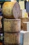 Stack of Cheddar cheese wheels on a market stall