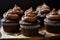 stack of chocolate cupcakes, each one topped with rich and creamy icing