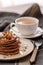 Stack of chocolate pancakes with maple syrup, honey and cup of coffee, nice snack