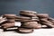 Stack of chocolate sandwich cookies on the rustic wooden background