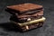 Stack of chocolate slices with mint leaf on a wooden table.Assortment of fine chocolates in white, dark, and milk chocolate. Sweet