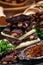 Stack of chocolate slices with mint leaf on a wooden table.Assortment of fine chocolates in white, dark, and milk chocolate. Sweet