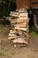Stack chopped birch firewood pile high in profile on dry ground background stocking firewood winter fireplace