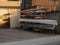 Stack of classic rowing boats in front of rowing club. Warm sunset light. Watersport equipment storage