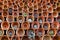 Stack of clay ceramic flowerpots laying on the side with succulent plants growing out of some