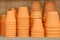 Stack of clay pots on a shelf