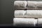 Stack of clean folded white beige terry towels on dark wall background. Laundry spa wellness cleanliness concept. Scandinavian