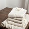Stack of clean freshly laundered, neatly folded women\\\'s clothes on wooden table.