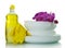 Stack of clean plates, detergent, sponge and gloves isolated on white