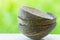 Stack of coconut shell bowls on green foliage background. Artisan craftsmanship eco-friendly materials dishware. Clean eating