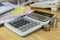 The stack of coin with calculator on wood table at office, concept of calculating expenses