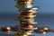 Stack of coins close up with blurred background. Euro coins stacked in a pile. Soft focus