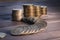 A stack of coins on a dark wooden surface. Russian metallic rubles