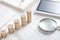 Stack of coins, magnifying glass, tablet, calculator