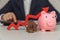 Stack of coins with red arrow, house key and piggy bank close-up. Business investment ideas