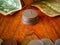 Stack of coins - on the top is an US quarter dollar. In the foreground is a pile of unspecified coins and a paper note in the