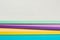 A stack of color notebooks, yellow, purple, green