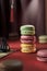 Stack of colored macaroons with different flavors - pistachio, raspberry, lemon. Creative advertisement for macaron product in