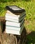 Stack of colorful books and electronic book reader