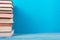 Stack of colorful books, grungy blue background, free copy space