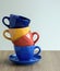 Stack of colorful coffee cups on table